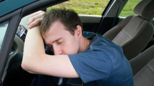 Man sleeps in a car - copyright: Yulia Gapeenko