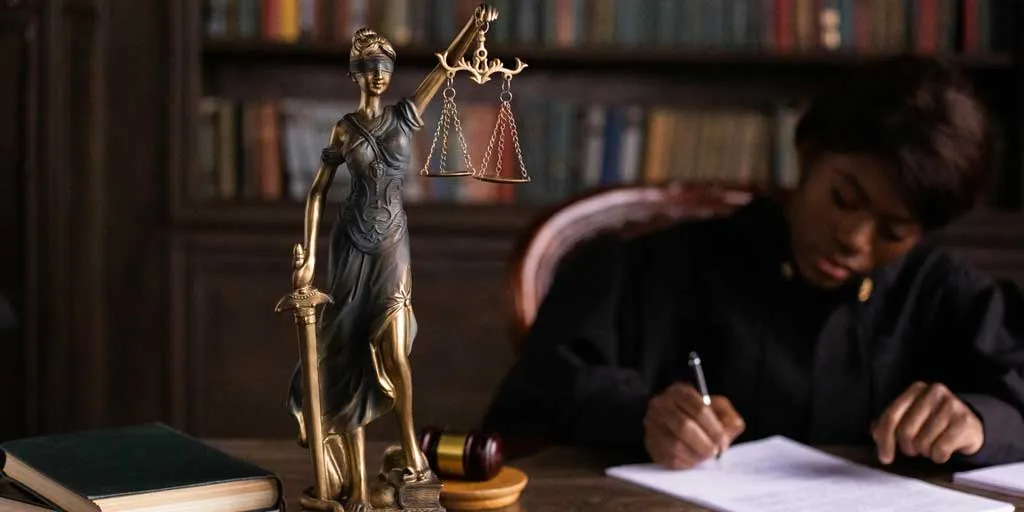 Judge at desk - Photo by Katrin Bolovtsova